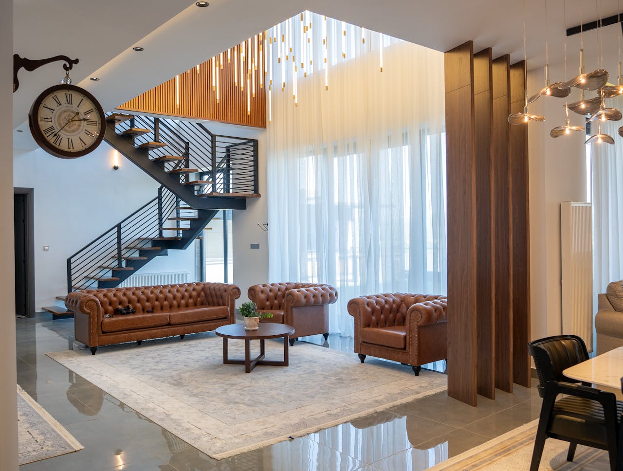 Elegant interior of a modern living room with stylish furniture and open staircase.